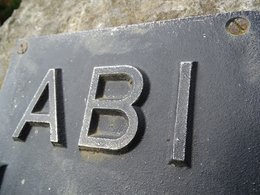 Das Schild mit den Buchstaben für ABI plastisch mit Metall dargestellt.