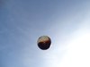 Ein Deutschlandfußball fliegt in der Luft vor blauem Himmel.