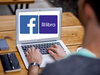 Ein Notebook zeigt das Logo von Facebook und das der geplanten Kryptowährung Libra von Facebook.