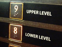 Knopfleiste in einem Fahrstuhl: Stockwerk 9 führt ins Upper Level, Stockwerk 8 ins Lower Level.