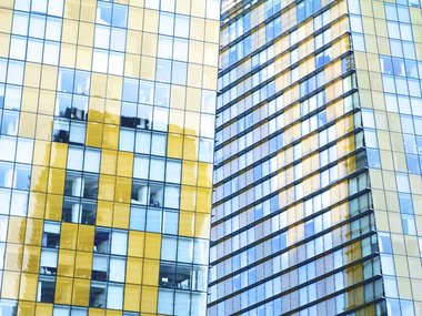 Fenster und Gebäude bilden mit gelber und blauer Farbe verschiedene Formen.
