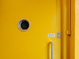 Eine gelbe Sicherheitstür von einem Lasten-Fahrstuhl.