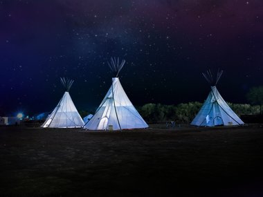 Weiße Indianerzelte in der Nacht.